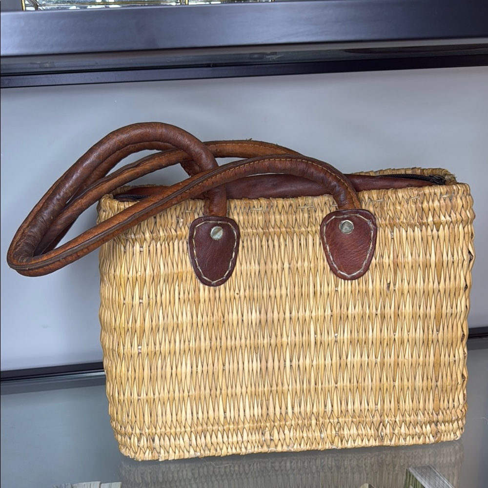 Vintage tan straw tote with brown leather handles